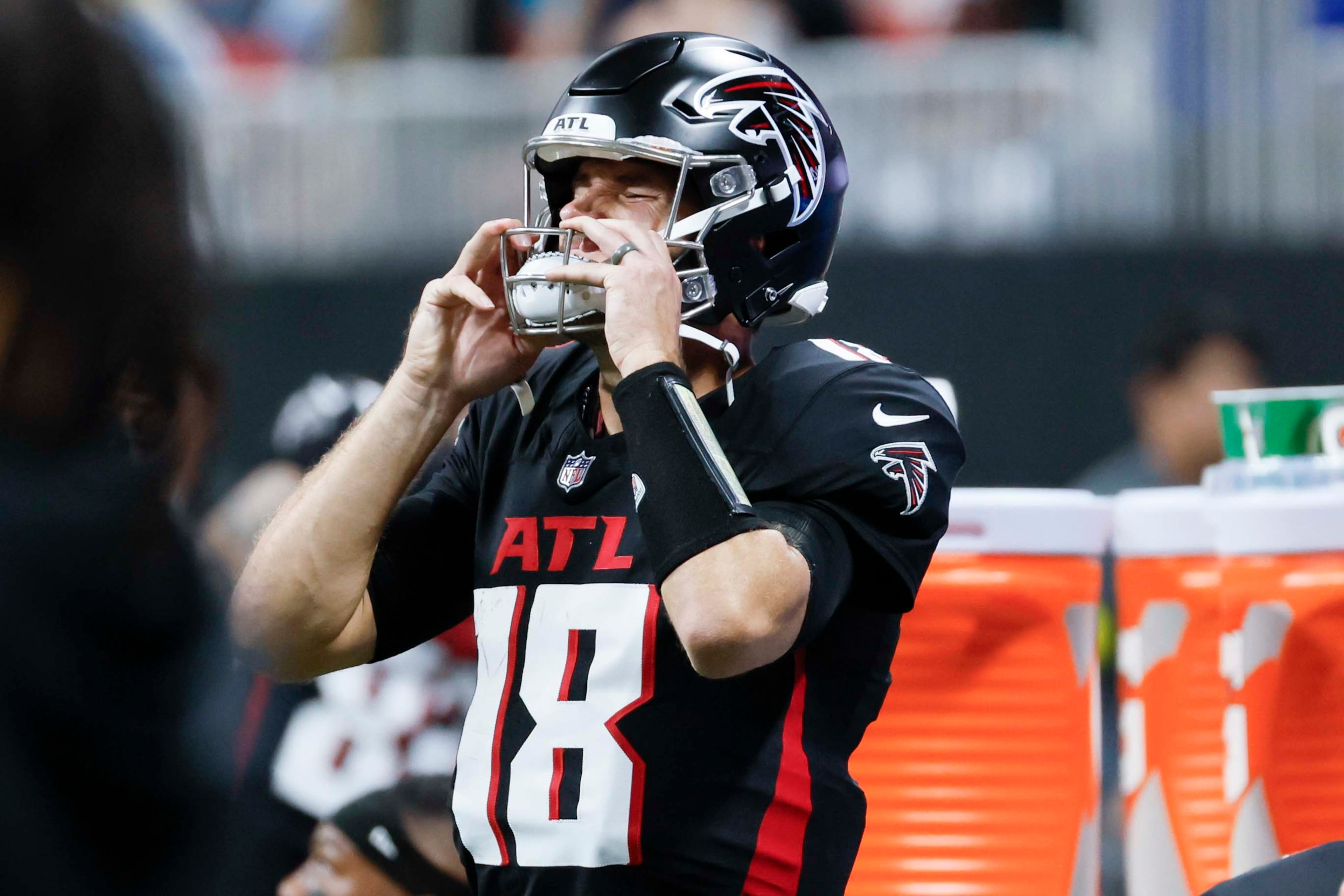 Atlanta Falcons quarterback Kirk Cousins adjusts his helmet during the second half of an NFL game against the Miami Dolphins at Mercedes-Benz Stadium in Atlanta on Sunday, Oct. 26, 2025. (Miguel Martinez/AJC)