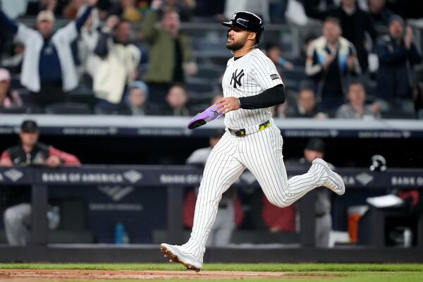 New York Yankees' Jasson Domínguez scores after Oswaldo Cabrera reaches on a throwing error by Arizona Diamondbacks first baseman Josh Naylor during the fourth inning of a baseball game, Tuesday, April 1, 2025, in New York. (AP Photo/Julia Demaree Nikhinson)