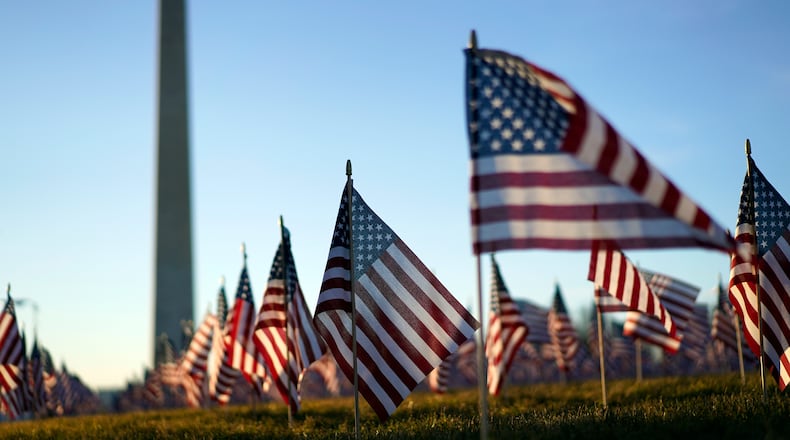 Flags line the National Mall, with the Washington Monument behind them, ahead of the inauguration of President-elect Joe Biden and Vice President-elect Kamala Harris on Tuesday, Jan. 19, 2021, in Washington , DC. (Kent Nishimura/Los Angeles Times/TNS)
