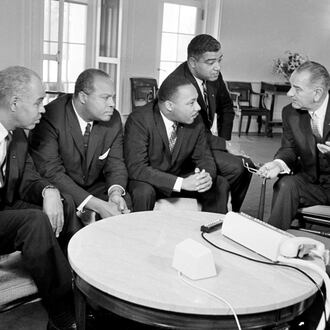 U.S. President Lyndon B. Johnson, right, talks with civil rights leaders in his White House office in Washington, D.C., Jan. 18, 1964. The Black leaders, from left, are Roy Wilkins, executive secretary of the NAACP; James Farmer, national director of the Committee on Racial Equality; the Rev. Martin Luther King Jr., head of the Southern Christian Leadership Conference; and Whitney Young, executive director of the Urban League. (AP file photo)