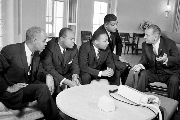 U.S. President Lyndon B. Johnson, right, talks with civil rights leaders in his White House office in Washington, D.C., Jan. 18, 1964. The Black leaders, from left, are Roy Wilkins, executive secretary of the NAACP; James Farmer, national director of the Committee on Racial Equality; the Rev. Martin Luther King Jr., head of the Southern Christian Leadership Conference; and Whitney Young, executive director of the Urban League. (AP file photo)