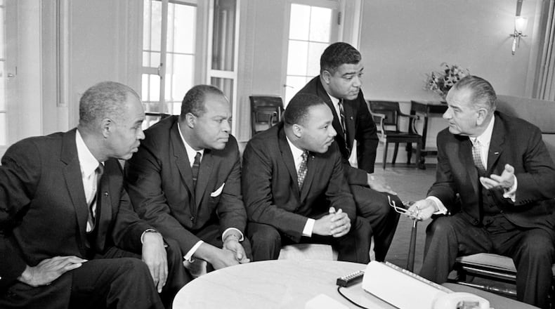 U.S. President Lyndon B. Johnson, right, talks with civil rights leaders in his White House office in Washington, D.C., Jan. 18, 1964. The Black leaders, from left, are Roy Wilkins, executive secretary of the NAACP; James Farmer, national director of the Committee on Racial Equality; the Rev. Martin Luther King Jr., head of the Southern Christian Leadership Conference; and Whitney Young, executive director of the Urban League. (AP file photo)