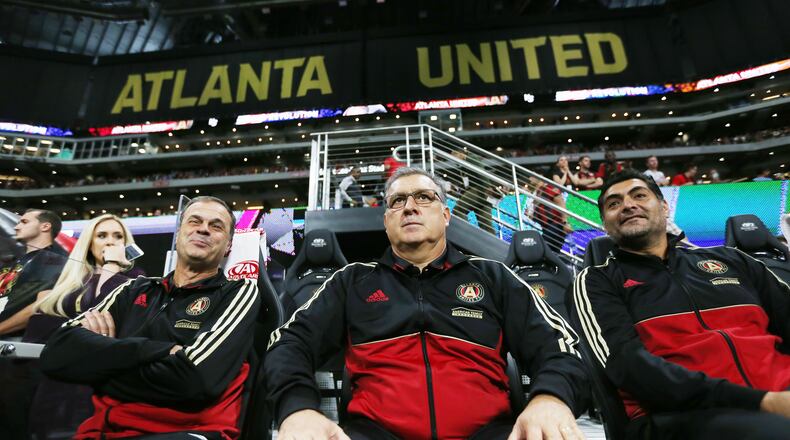In this file photo Atlanta United coach Gerardo 'Tata 'Martino watches his team fromthe bench with his coaching staff.