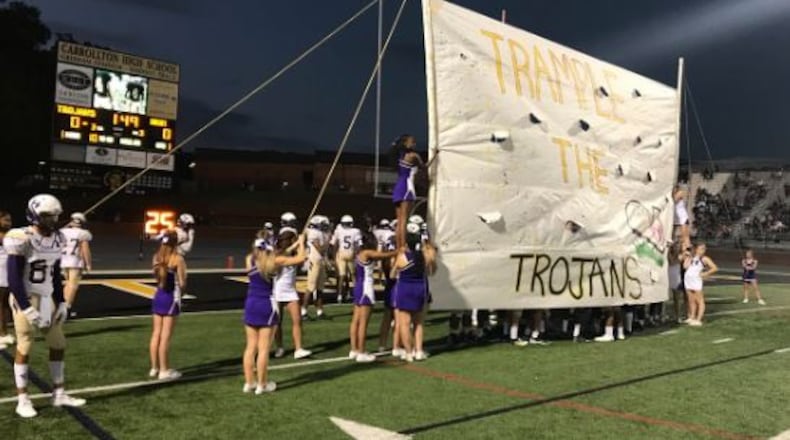 Hiram cheerleaders prepare the run-through sign. (Photo courtesy of Hiram Facebook page)
