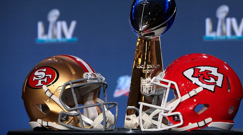 The Vince Lombardi Trophy is displayed with helmets of the San Francisco 49ers and Kansas City Chiefs. (Cliff Hawkins/Getty Images)