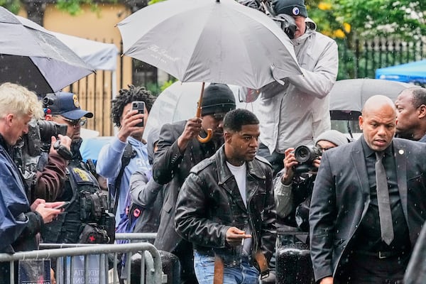 Rapper Kid Cudi, center, arrives at Federal Court for the trial of Sean "Diddy" Combs, in New York, Thursday, May 22, 2025. (AP Photo/Richard Drew)