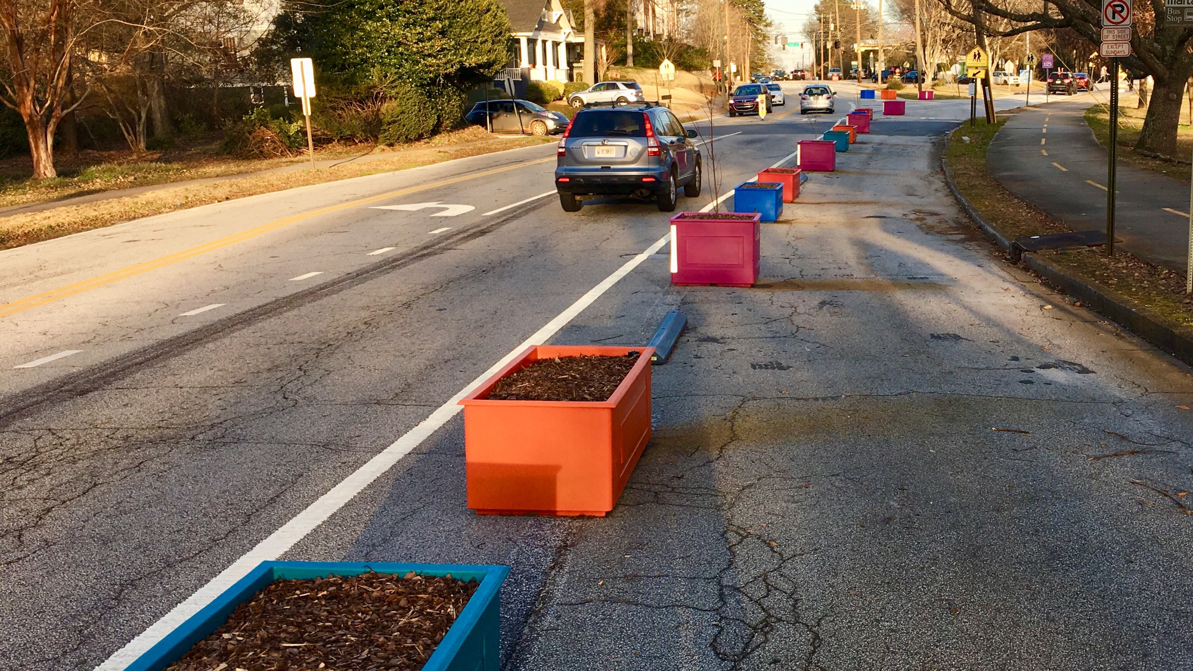 The planter boxes lining West Howard Avenue in Decatur are being removed. The city installed them in 2019. (Bill Banks for the AJC)