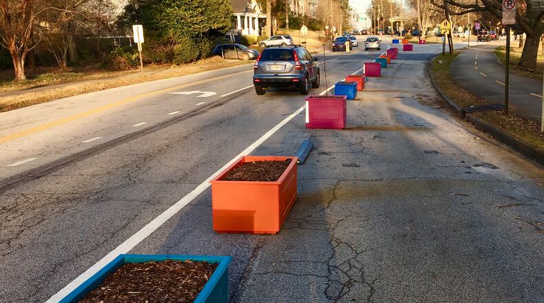 A portion of the 197 planter boxes lining West Howard Avenue looking east toward the complicated Atlanta Avenue/railroad tracks/College Avenue intersection. Those boxes currently empty will receive a wildflower mix in the coming weeks. The Atlanta-Stone Mountain PATH trail is on the far right. Bill Banks for the AJC