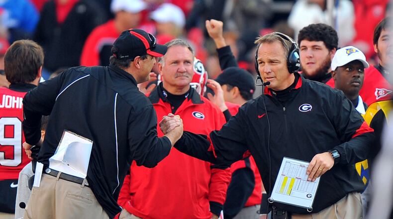 Georgia head coach Mark Richt, right and defensive coordinator Todd Grantham celebrate during the final seconds against Kentucky at Sanford Stadium Saturday November 19, 2011.