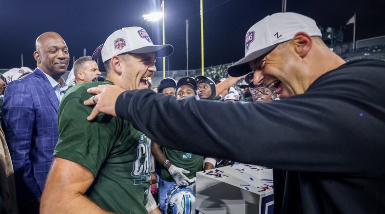 Tulane head coach Jon Sumrall, right, reacts with Tulane quarterback Jake Retzlaff (12) after winning the American Conference championship NCAA college football game against North Texas in New Orleans, Friday, Dec. 5, 2025. (AP Photo/Matthew Hinton)