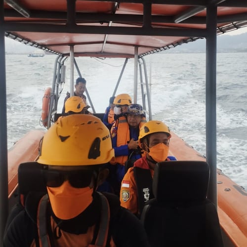 In this photo released by the Indonesian National Search and Rescue Agency (BASARNAS), rescuers sit in a rubber boat during the search for journalists missing while covering the eruption of Mount Anak Krakatau, in the waters off Anyer, Indonesia, Wednesday, Sept. 9, 2026. (BASARNAS via AP)