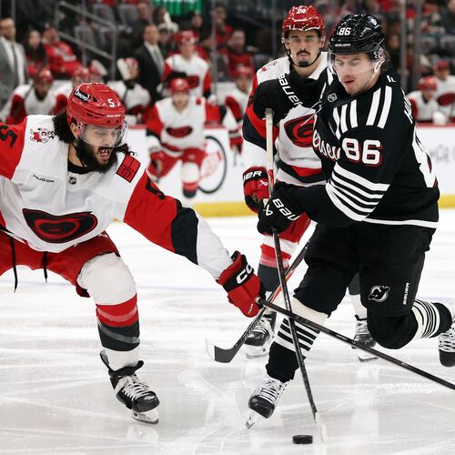 New Jersey Devils center Jack Hughes (86) has his shot knocked away by Carolina Hurricanes defenseman Jalen Chatfield (5) during the second period of an NHL hockey game Saturday, Jan. 17, 2026, in Newark, N.J. (AP Photo/Adam Hunger)