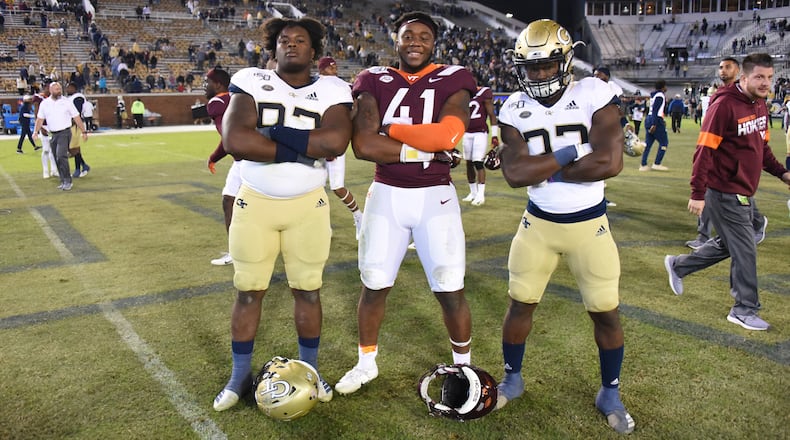 Brothers Georgia Tech defensive lineman Ja'Quon Griffin (92), Virginia Tech defensive lineman Jaylen Griffin (41) and Georgia Tech defensive lineman Ja'Quon Griffin (92) pose following the Hokies' 45-0 win over the Jackets Nov. 16, 2019,  at Bobby Dodd Stadium in Atlanta.