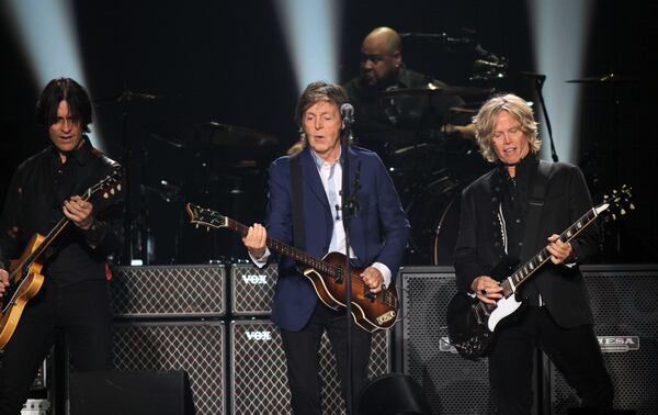 Oct. 15, 2014 ATLANTA: The legendary Sir Paul McCartney jamming with two of his guitarist at the Philips Arena in Atlanta Wednesday. (Akili-Casundria Ramsess/Special to the AJC) Guitarists Rusty Anderson (left) and Brian Ray and drummer Abe Laboriel allow McCartney plenty of musical freedom. Photo: Akili-Casundria Ramsess/Special to the AJC
