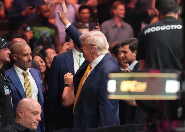President Donald Trump waves to the crowd as he arrives at a mixed martial arts fight at UFC 314, Saturday, April 12, 2025, in Miami. (AP Photo/Lynne Sladky)