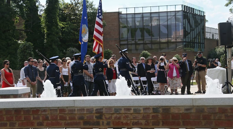 May 27, 2013 - Atlanta - All stand as the Honor Guard from the 94th Airlift Wing, US Air Force Reserve, presents the colors. The newly expanded Veterans Park at the Atlanta History Center was formally dedicated on Memorial Day. Funded by a grant from The Home Depot Foundation, Veterans Park at the Atlanta History Center was designed by landscape architect Mack Cain of Jacobs. Originally conceived in 2000 with the help of the Atlanta Vietnam Veterans Business Association, Veterans Park began as a small garden honoring veterans from the Vietnam War. Lt. Colonel Richard A. Lester, US Army Retired, and a Vietnam helicopter pilot, dedicated the park with a soil ceremony. Soils from every major conflict in which our country has fought were distributed on the grounds. BOB ANDRES / BANDRES@AJC.COM
