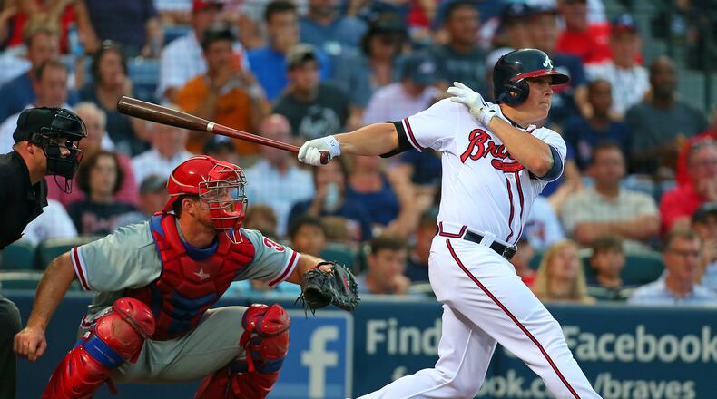 Braves pitcher Kris Medlen hits a RBI double with Phillies catcher Erik Kratz looking on for a 1-0 lead in the second inning of their MLB game at Turner Field on Tuesday, August 13, 2013, in Atlanta. CURTIS COMPTON / CCOMPTON@AJC.COM
