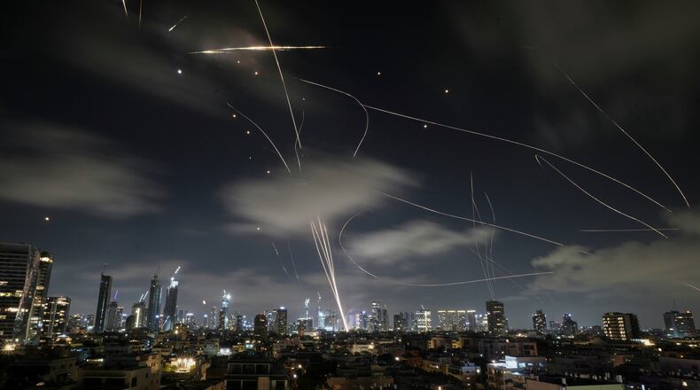 FILE - The Israeli Iron Dome air defense system intercepts missiles during an Iranian attack on Tel Aviv, Israel, June 18, 2025. (AP Photo/Leo Correa, File)