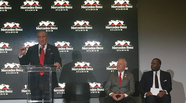 Falcons owner Arthur Blank speaks as Gov. Nathan Deal and Atlanta Mayor Kasim Reed listen. AJC/Greg Bluestein
