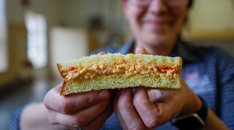 MaryBeth Hornbeck, family and consumer sciences program development coordinator for UGA Extension, prepares to take a bit of a classic pimento cheese sandwich.
(Miguel Martinez/ AJC)