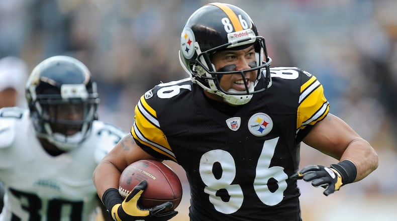 In this Sunday, Oct. 16, 2011, file photo, Pittsburgh Steelers wide receiver Hines Ward (86) runs past Jacksonville Jaguars defensive back Drew Coleman (30) after making a catch in the second quarter of an NFL football game in Pittsburgh. Ward's 12,083 receiving yards are the most in NFL history by a former Georgia high school player. Ward was a multi-posiiton player at Forest Park in the 1990s. (Don Wright/AP File)