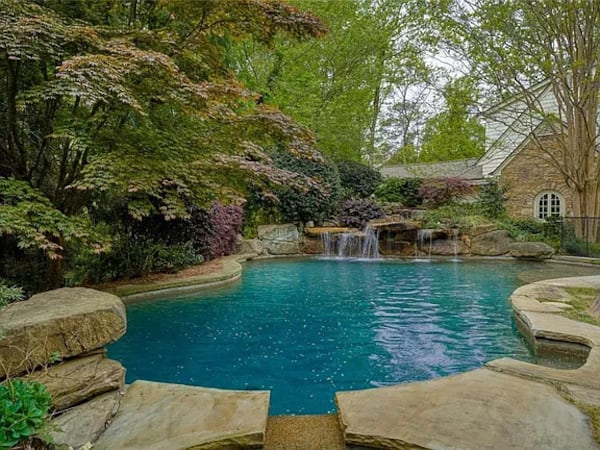 Josh Brolin's home for sale in Atlanta features a large heated gunite pool with a hot tub, two waterfalls, and a custom jumping rock. (Courtesy of Jacob Bean)