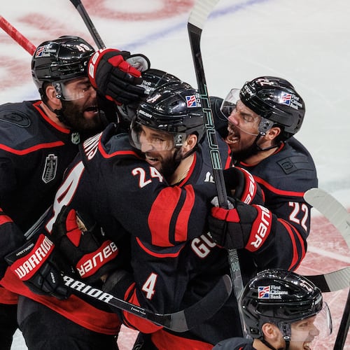 Carolina Hurricanes' Jordan Martinook (48), Seth Jarvis (24), Shayne Gostisbehere (4), and Logan Stankoven (22) ceelbrate after Jarvis scored the game-winning goal against against the Vegas Golden Knights in overtime of Game 2 of the NHL hockey Stanley Cup Final series in Raleigh, N.C., Thursday, June 4, 2026. (AP Photo/Ben McKeown)
