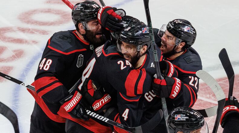 Carolina Hurricanes' Jordan Martinook (48), Seth Jarvis (24), Shayne Gostisbehere (4), and Logan Stankoven (22) ceelbrate after Jarvis scored the game-winning goal against against the Vegas Golden Knights in overtime of Game 2 of the NHL hockey Stanley Cup Final series in Raleigh, N.C., Thursday, June 4, 2026. (AP Photo/Ben McKeown)