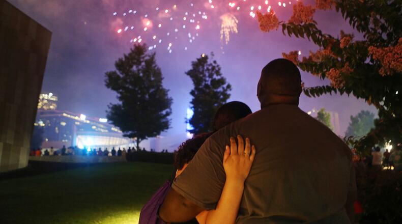 A man and woman embrace while watching fireworks in Atlanta. Christina Matacotta/Christina.Matacotta@ajc.com