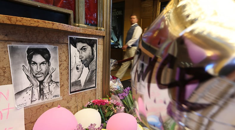 Drawings, flowers and balloons form a memorial to Prince in front of the Fox Theatre, where the musician played his final public concert a week before he died.