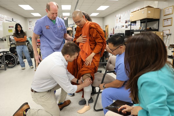 Buddhist monk Bhante Dam Phommasan, injured last fall in a cross-country "Walk for Peace," being fitted with a prosthetic leg this week at Mercer University in Macon. (Courtesy of Mercer University)