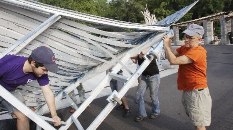 Producing artistic director Richard Garner helps with the load in of the set at Piedmont Park fpr Shakespeare in the Park in 2012. BOB ANDRES / BANDRES@AJC.COM
