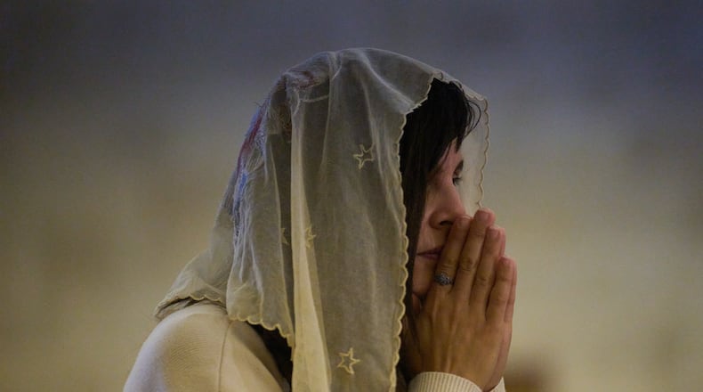 A Christian pilgrim attends a Mass in the Basilica of the Transfiguration on Mount Tabor, northern Israel, Aug. 6, 2026. (AP Photo/Ariel Schalit)
