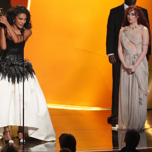Olivia Dean accepts the award for best new artis during the 68th annual Grammy Awards on Sunday, Feb. 1, 2026, in Los Angeles. Chappell Roan looks on from right. (AP Photo/Chris Pizzello)