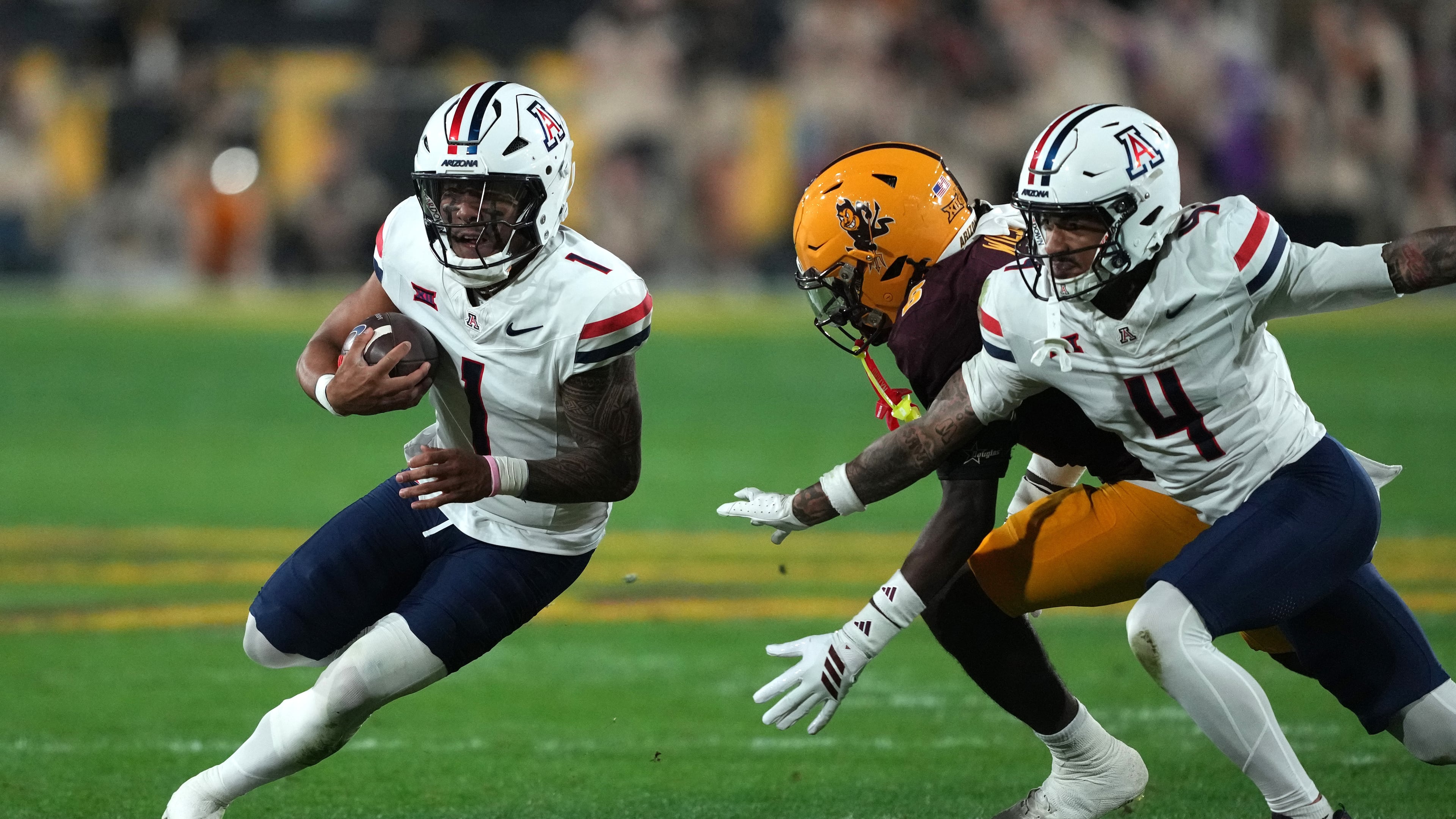 Arizona quarterback Noah Fifita (1) runs the ball against Arizona State in the first half of an NCAA college football game, Friday, Nov. 28, 2025, in Tempe, Ariz. (AP Photo/Rick Scuteri)