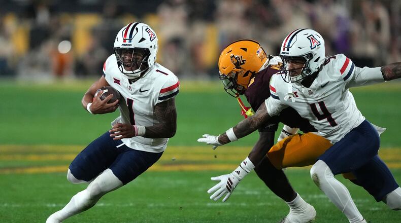 Arizona quarterback Noah Fifita (1) runs the ball against Arizona State in the first half of an NCAA college football game, Friday, Nov. 28, 2025, in Tempe, Ariz. (AP Photo/Rick Scuteri)