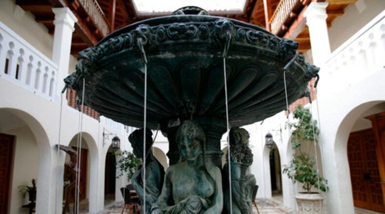A fountain in the courtyard of the Versace Mansion in Miami Beach. Modeled after Alcazar de Colon, the Dominican Republic house built by Christopher Columbus' family in 1510, Casa Casuarina is a three-story, Mediterranean-style home surrounded by a high wall on a fashionable stretch of Ocean Drive. It was built in 1930 by Standard Oil heir Alden Freeman, later became a hotel, spiraled into disrepair, and was at one point a hostel with rooms as little as $1 a night. Two men were found dead Wednesday inside a luxury hotel room at the former Versace Mansion in Miami Beach where the acclaimed fashion designer was shot to death 24 years ago.