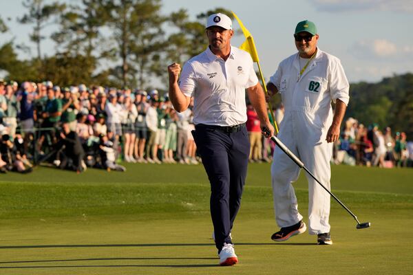 Bryson DeChambeau celebrates after a birdie on the 18th hole during the third round at the Masters golf tournament, Saturday, April 12, 2025, in Augusta, Ga. (AP Photo/David J. Phillip)
