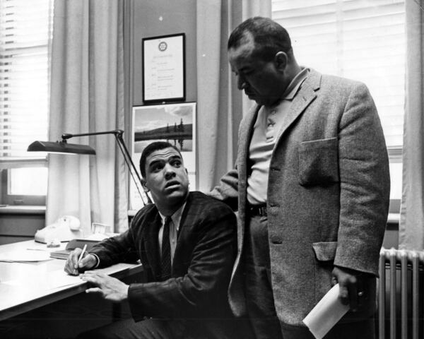 Hamilton E. Holmes (seated), pictured with his father, Alfred Holmes, joined Charlayne Hunter-Gault as the first Black students at the University of Georgia in 1961. (AJC file)