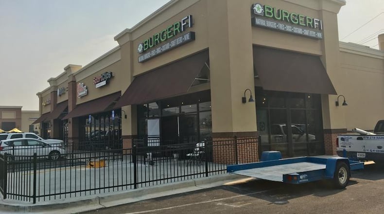 Construction is well underway at a new BurgerFi location on Duluth Highway near Lawrenceville. TYLER ESTEP /TYLER.ESTEP@AJC.COM