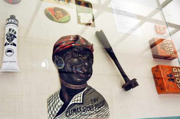 In this Jan. 11, 2018 photo, artifacts inside a display case, including a branding iron, are included in the slavery and segregation collection by Alan Page, NFL Hall of Famer and retired Minnesota Supreme Court Justice, and his wife, Diane Sims Page, displayed at the Minneapolis Central Library this month in time for Super Bowl visitors and thousands of other people expected to flock to downtown for the festivities. (AP Photo/Steve Karnowski)