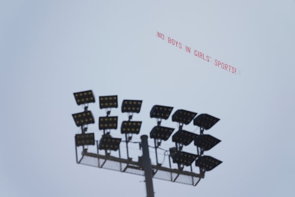 A banner reading "NO BOYS IN GIRLS' SPORTS!" is flown above Veteran's Memorial Stadium during the California high school track-and-field championships in Clovis, Calif., Friday, May 30, 2025. (AP Photo/Jae C. Hong)