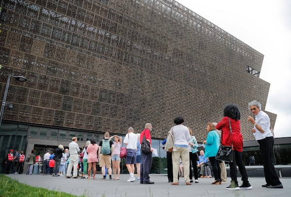 Lucille Simpson, far right, and her daughter Gwendolyn Norman, both from Detroit, Mich., wait in line to enter the Smithsonian National Museum of African American History and Cultural on the National Mall in Washington, Monday, May 1, 2017. The hottest ticket in Washington right now is for the new museum, where thousands of tickets are snapped up each month within minutes of being released, a full seven months after the museum opened.  (AP Photo/Pablo Martinez Monsivais)