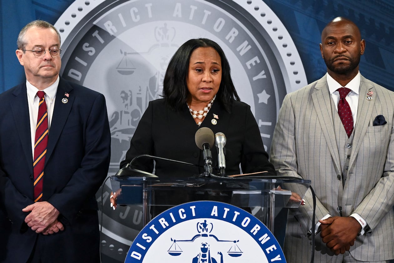 Fulton DA Fani Willis (center) with Nathan J. Wade (right), the special prosecutor she hired to manage the Trump case and had a romantic relationship with, at a news conference announcing charges against President-elect Donald Trump and others in Atlanta, Aug. 14, 2023. Georgia’s Supreme Court on Tuesday, Sept. 16, 2025, upheld an appeals court's decision to disqualify Willis from the election interference case against Trump and his allies. (Kenny Holston/New York Times)