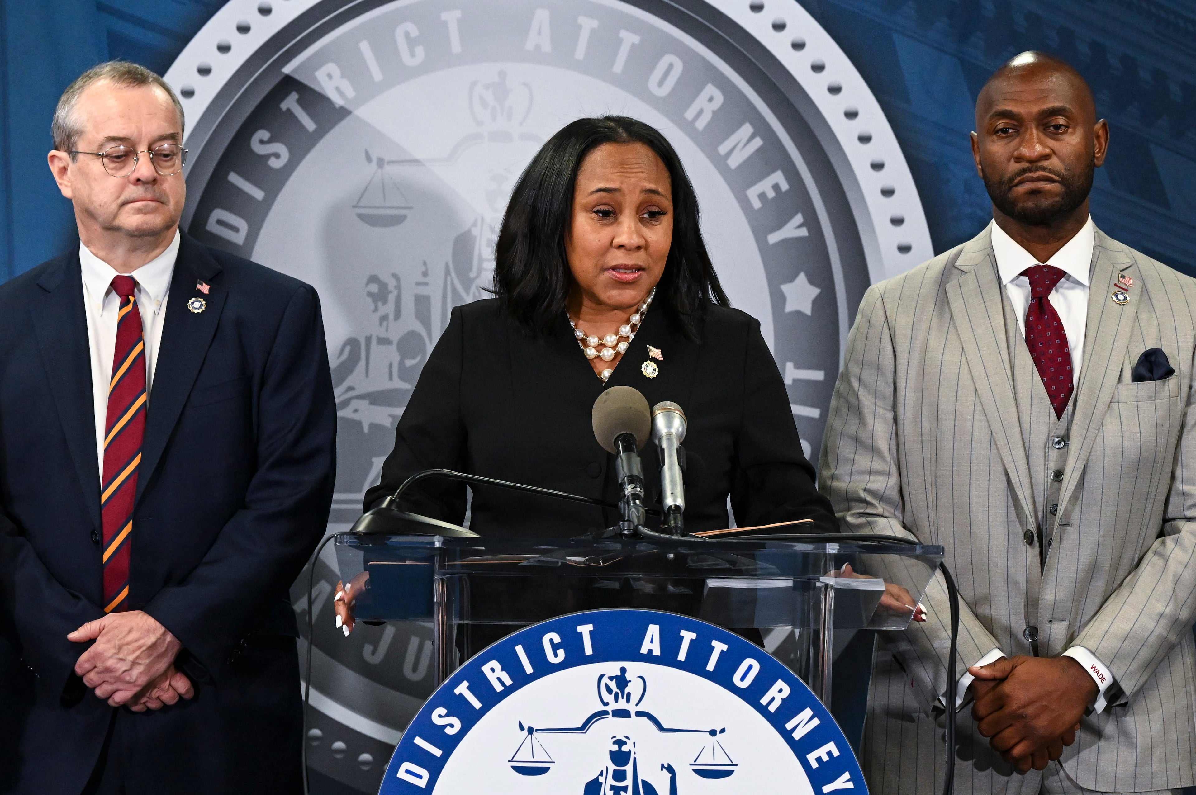 Fulton DA Fani Willis (center) with Nathan J. Wade (right), the special prosecutor she hired to manage the Trump case and had a romantic relationship with, at a news conference announcing charges against President-elect Donald Trump and others in Atlanta, Aug. 14, 2023. Georgia’s Supreme Court on Tuesday, Sept. 16, 2025, upheld an appeals court's decision to disqualify Willis from the election interference case against Trump and his allies. (Kenny Holston/New York Times)