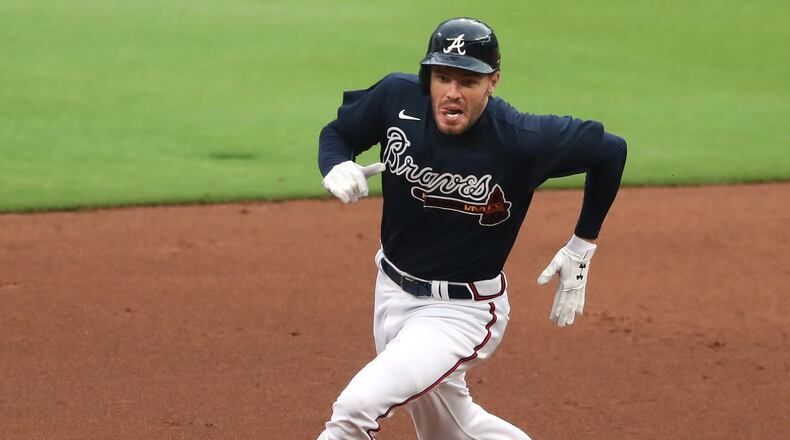 071820 Atlanta: Atlanta Braves first baseman Freddie Freeman rounds second base hitting a triple during the second inning in his first game back since testing positive with COVID-19 in an intrasquad game on Saturday, July 18, 2020 in Atlanta. Curtis Compton ccompton@ajc.com