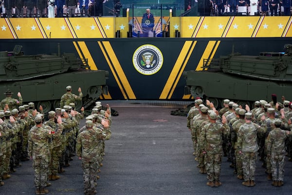 President Donald Trump participates in a reenlistment ceremony for Army soldiers during a military parade commemorating the Army's 250th anniversary Saturday, June 14, 2025, in Washington. (AP Photo/Julia Demaree Nikhinson)