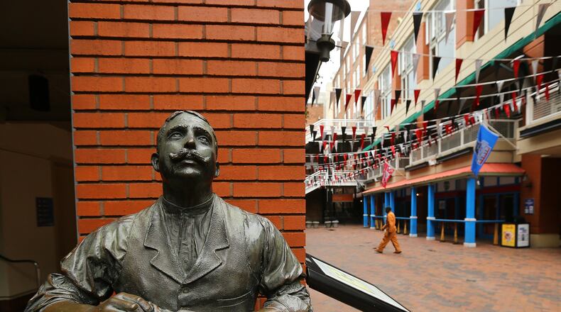 A visitor makes his way through Kenny’s Alley, an area occupied by saloons and livery stables in the late 1870s, at Underground Atlanta on Wednesday, March 19, 2014, in Atlanta. Mayor Kasim Reed has vowed to sell the struggling downtown shopping and entertainment complex to a private developer.