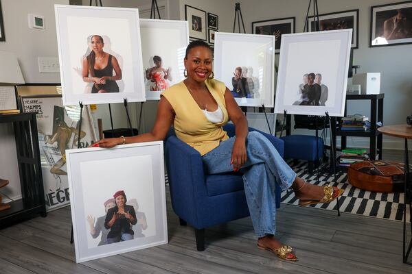 Author Bessie Akuba Winn poses with photographs from her book, "Our Kind of Women," at her home in Lilburn in August. (Jason Getz/AJC)