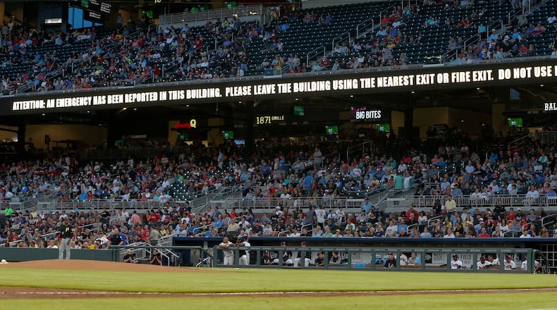 An emergency message warning flashes on a sign board during the game between the Braves and Pirates at SunTrust Park. A loud alarm signal and flashing lights startled fans Tuesday night, just a day after an attack by a suicide bomber at a pop concert in Manchester, England, left at least 22 dead. (AP Photo/John Bazemore)